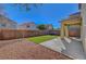 View of a backyard with a covered patio, block wall, and a well-maintained lawn at 8040 Marshall Canyon Dr, Las Vegas, NV 89166