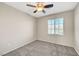 A cozy bedroom features neutral walls, ceiling fan, and bright window at 8040 Marshall Canyon Dr, Las Vegas, NV 89166