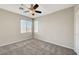 Bedroom features neutral walls, a ceiling fan, carpet, and bright windows at 8040 Marshall Canyon Dr, Las Vegas, NV 89166