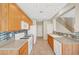 Well-lit kitchen featuring tile backsplash, white appliances, and wood cabinets for a functional space at 8040 Marshall Canyon Dr, Las Vegas, NV 89166