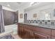 Modern bathroom with dark vanity, granite countertop, and tile shower at 8255 Las Vegas Blvd # 1505, Las Vegas, NV 89123