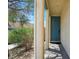 Home's exterior with teal front door and stone columns at 8261 Peaceful Mountain Ave, Las Vegas, NV 89178