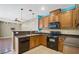 Modern kitchen with wood cabinets and granite countertops at 8261 Peaceful Mountain Ave, Las Vegas, NV 89178