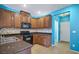 Modern kitchen with wood cabinets and blue walls at 8261 Peaceful Mountain Ave, Las Vegas, NV 89178