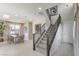 Modern staircase with dark wood railings and neutral carpeting at 8405 Sycamore Creek St, Las Vegas, NV 89148