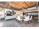 Open concept dining area with glass table and white chairs, exposed ductwork, and modern chandelier at 900 Las Vegas Blvd # 904, Las Vegas, NV 89101