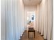 Long hallway with white curtains and a mid-century modern bench at 900 Las Vegas Blvd # 904, Las Vegas, NV 89101