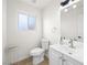 Well-lit bathroom with single sink vanity and a window providing natural light at 908 Primrose Ln, Henderson, NV 89011