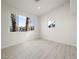 Bright bedroom featuring two windows offering an outside view and light wood-look floors at 908 Primrose Ln, Henderson, NV 89011