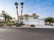 Two-story home with three-car garage, desert landscaping, palm trees and large driveway at 908 Primrose Ln, Henderson, NV 89011