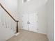 Bright foyer with tiled floor and a staircase featuring white spindles at 908 Primrose Ln, Henderson, NV 89011