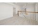 Upper hallway showcasing wood railing, neutral walls, and wood-look flooring at 908 Primrose Ln, Henderson, NV 89011