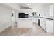 Bright kitchen featuring a large island, white cabinets, and modern black appliances at 908 Primrose Ln, Henderson, NV 89011