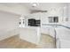 Modern kitchen with white cabinetry and tile flooring at 908 Primrose Ln, Henderson, NV 89011