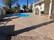 Large concrete pool deck, desert landscaping with view of the pool and backyard at 908 Primrose Ln, Henderson, NV 89011