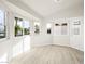 Bright sunroom with multiple windows and light-colored wood flooring at 908 Primrose Ln, Henderson, NV 89011