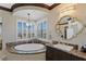 Spa-like bathroom featuring a large soaking tub and a window with a view at 9204 Tesoras Dr # 401, Las Vegas, NV 89144