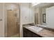 Modern bathroom with a walk-in shower and marble vanity at 9204 Tesoras Dr # 401, Las Vegas, NV 89144