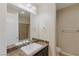 Clean bathroom with a marble vanity and a bathtub at 9204 Tesoras Dr # 401, Las Vegas, NV 89144