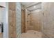 Large walk-in shower with glass block accents and neutral tile at 9204 Tesoras Dr # 401, Las Vegas, NV 89144