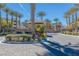 Gated community entrance with palm trees and well-manicured landscaping at 9204 Tesoras Dr # 401, Las Vegas, NV 89144