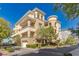 Three-story building with balconies and garage access at 9204 Tesoras Dr # 401, Las Vegas, NV 89144