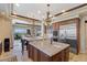 Island kitchen with granite counters and breakfast bar at 9204 Tesoras Dr # 401, Las Vegas, NV 89144