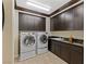 Laundry room with washer, dryer, and ample cabinet space at 9204 Tesoras Dr # 401, Las Vegas, NV 89144