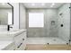 Spa-like bathroom featuring a walk-in shower, pebble floor, and white vanity at 10505 Novella Ct, Las Vegas, NV 89135