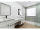 Elegant bathroom with white vanities, quartz countertops, and a large walk-in shower at 10505 Novella Ct, Las Vegas, NV 89135