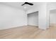 Simple bedroom with light wood floors, a ceiling fan and a closet at 10505 Novella Ct, Las Vegas, NV 89135