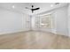 Bright bedroom with bay window, wood-look floors, and a ceiling fan at 10505 Novella Ct, Las Vegas, NV 89135