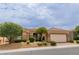 Single-story home with a two-car garage and nicely landscaped yard at 10505 Novella Ct, Las Vegas, NV 89135