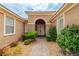 Inviting front entrance with arched doorway and well-manicured landscaping at 10505 Novella Ct, Las Vegas, NV 89135