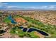 Aerial view of community, showcasing golf course and serene lakes at 10813 Black Ledge Ave, Las Vegas, NV 89134