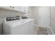 Bright laundry room, featuring washer, dryer, and ample cabinetry at 10813 Black Ledge Ave, Las Vegas, NV 89134