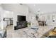 Open living area with wood-look floors and a view of the dining area and kitchen at 10813 Black Ledge Ave, Las Vegas, NV 89134