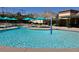 Community pool with turquoise water and umbrellas at 10813 Black Ledge Ave, Las Vegas, NV 89134