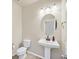 Clean powder room with pedestal sink and oval mirror at 1112 Via San Pietro, Henderson, NV 89011