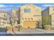 Two-story house with tan exterior and two-car garage at 1112 Via San Pietro, Henderson, NV 89011