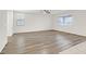 Spacious living room with wood-look flooring and ceiling fan at 1112 Via San Pietro, Henderson, NV 89011