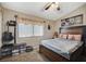 Bedroom with wood bed frame, guitar, and shoe storage at 1125 Neva Ranch Ave, North Las Vegas, NV 89081