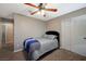 Bedroom with gray and blue bedding and ceiling fan at 1125 Neva Ranch Ave, North Las Vegas, NV 89081