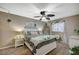 Bedroom with white bed frame, ceiling fan, and plants at 1125 Neva Ranch Ave, North Las Vegas, NV 89081