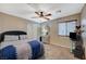 Bedroom with a tufted headboard, ceiling fan and TV stand at 1125 Neva Ranch Ave, North Las Vegas, NV 89081