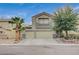 Two-story house with a three-car garage and landscaped front yard at 1125 Neva Ranch Ave, North Las Vegas, NV 89081