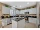 Modern kitchen with granite countertops, white cabinets, and an island at 1125 Neva Ranch Ave, North Las Vegas, NV 89081