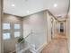 Upstairs hallway with carpet, white railings, and doors to bedrooms at 1125 Neva Ranch Ave, North Las Vegas, NV 89081