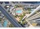 High-rise building with multiple pools and surrounding landscape at 135 E Harmon Ave # 718, Las Vegas, NV 89109