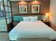 King-size bed with teal headboard in a condo bedroom at 135 E Harmon Ave # 718, Las Vegas, NV 89109